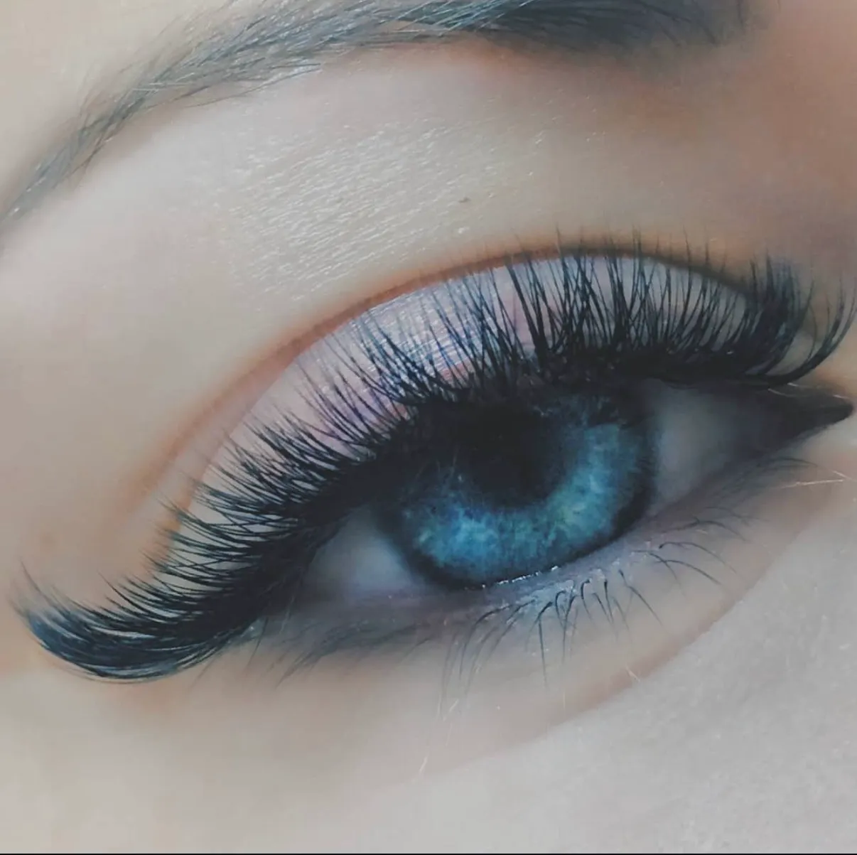 Close view of a client's eye with an elongated Cat Eye lash extension result.