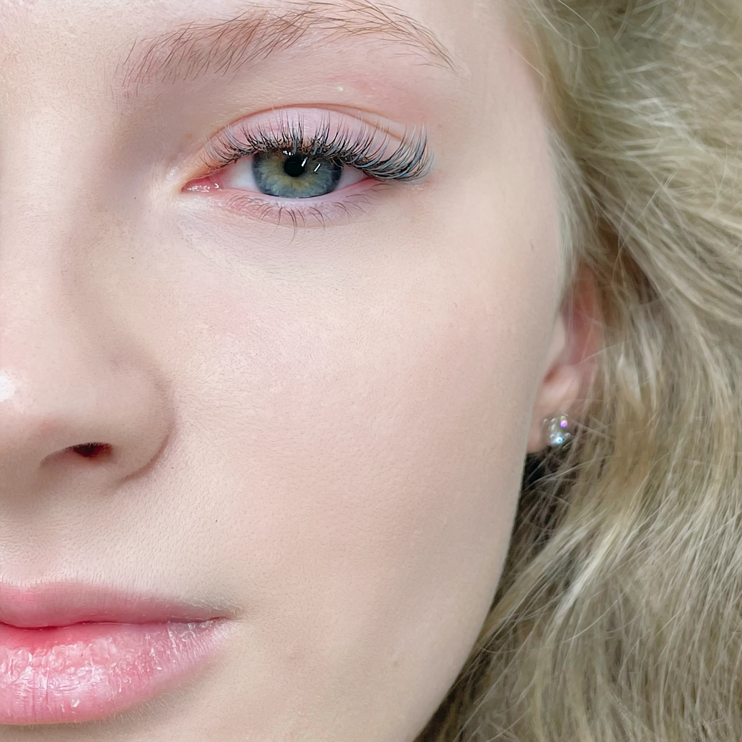 Portrait detail showing a light lash result with subtle blue accents.