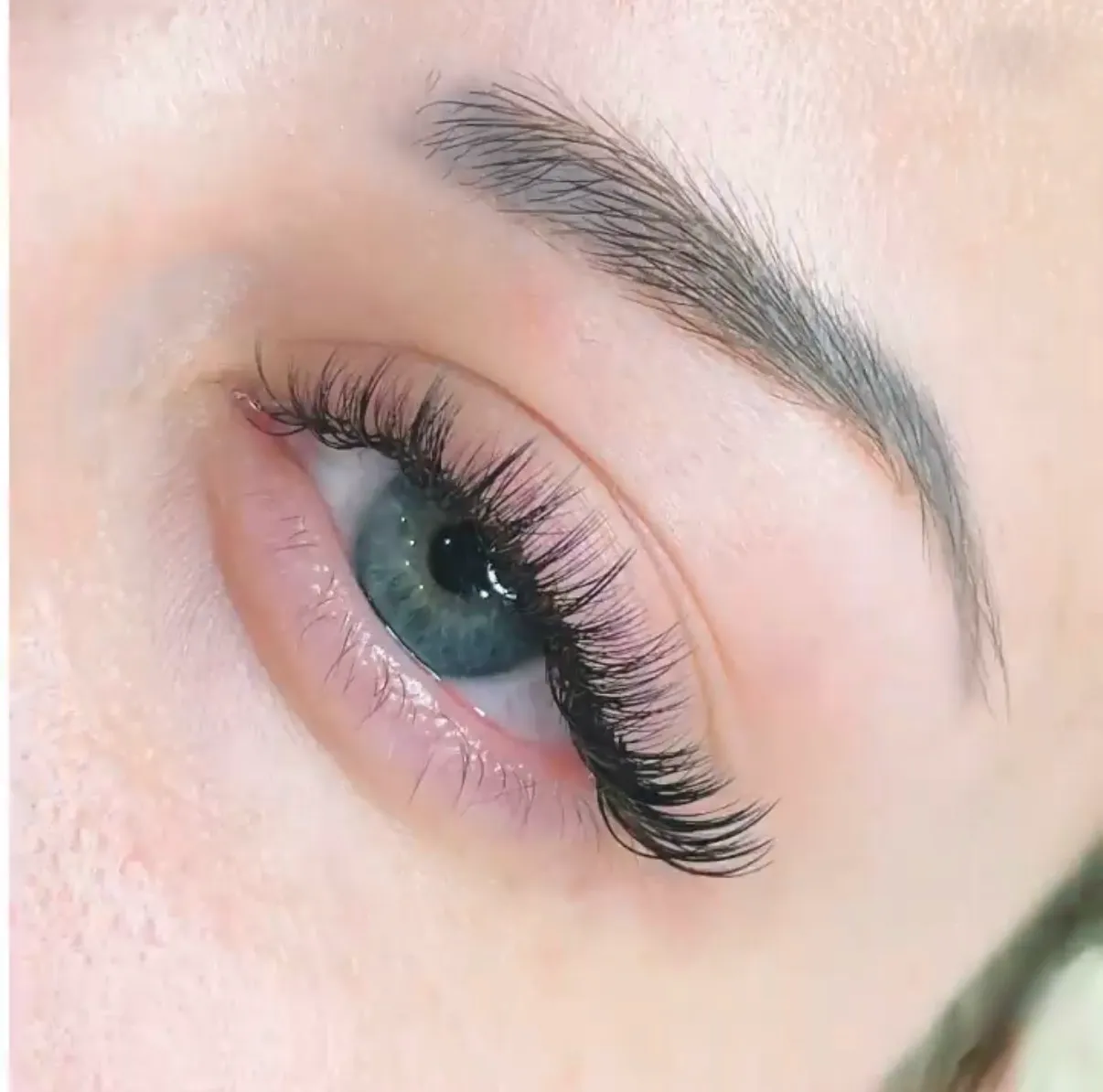 Close view of a client's eye with a textured Wispy lash extension result.